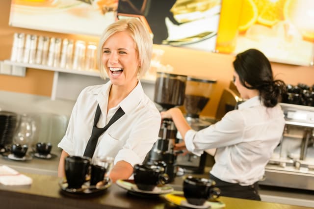 Waitress serving coffee cups making espresso woman cafe bar working