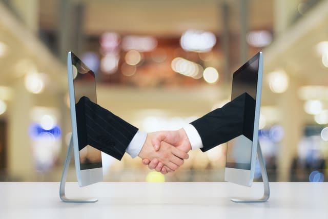Computer communication concept with human handshake