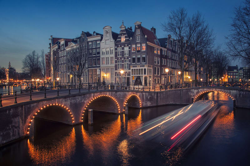 Amsterdam, Netherlands canals and bridges. Night view of Keizersgracht and famous touristic place