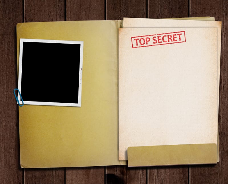 folder with TOP SECRET stamped across the front page and a blank photograph