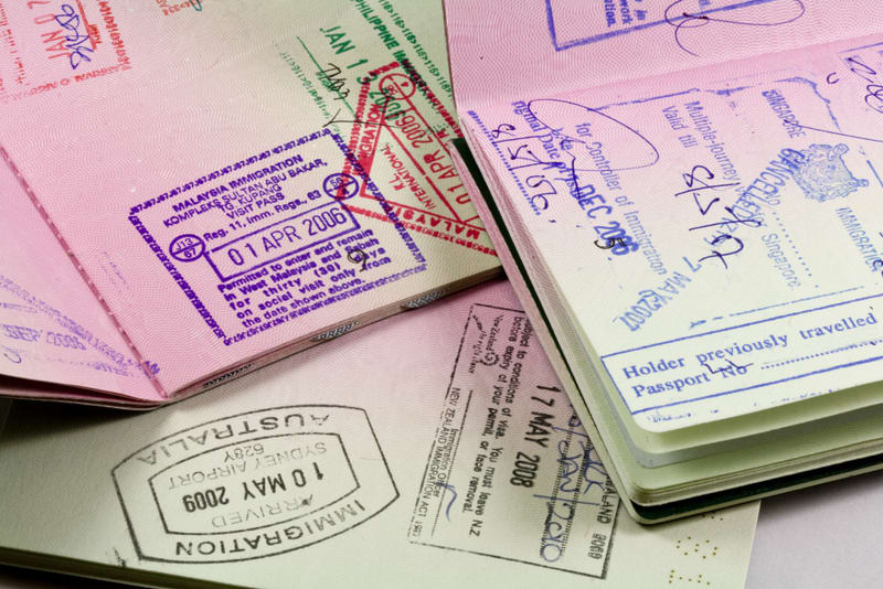 set of passports with visa and immigration stamps for travel to asia