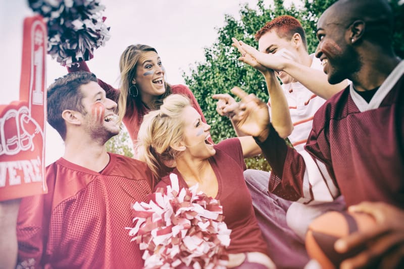 Series with college football fans tailgating and having fun before the game.