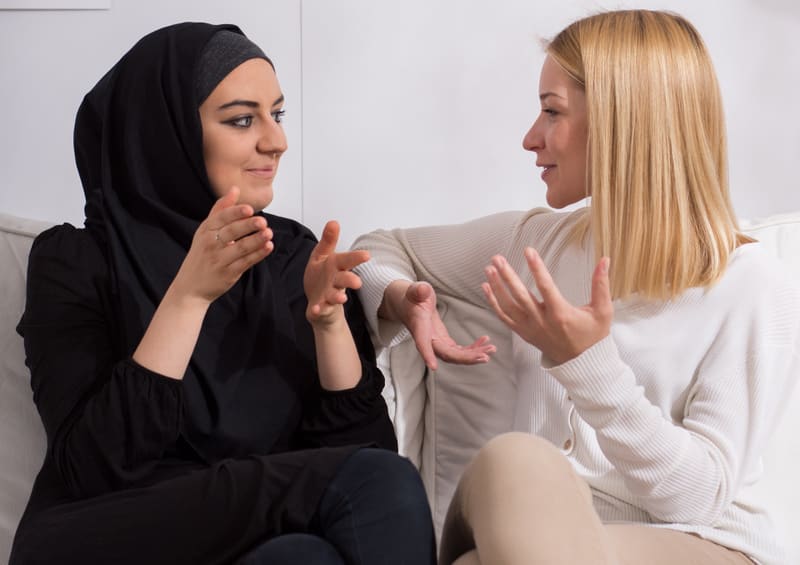 Two beautiful girls of different ethnicity talking