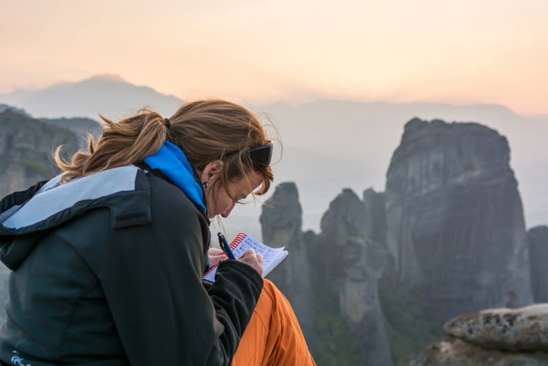 Girl writting her thoughts with a spectacular view