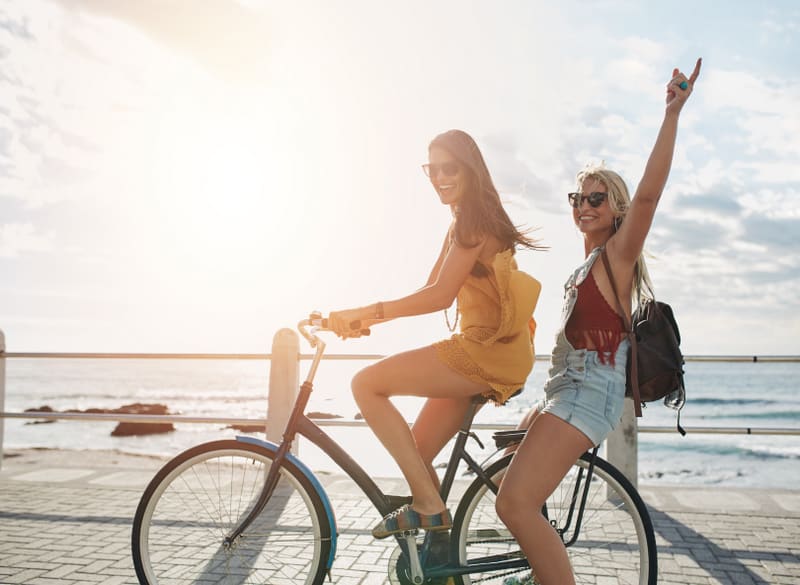 Happy young women enjoying bike ride