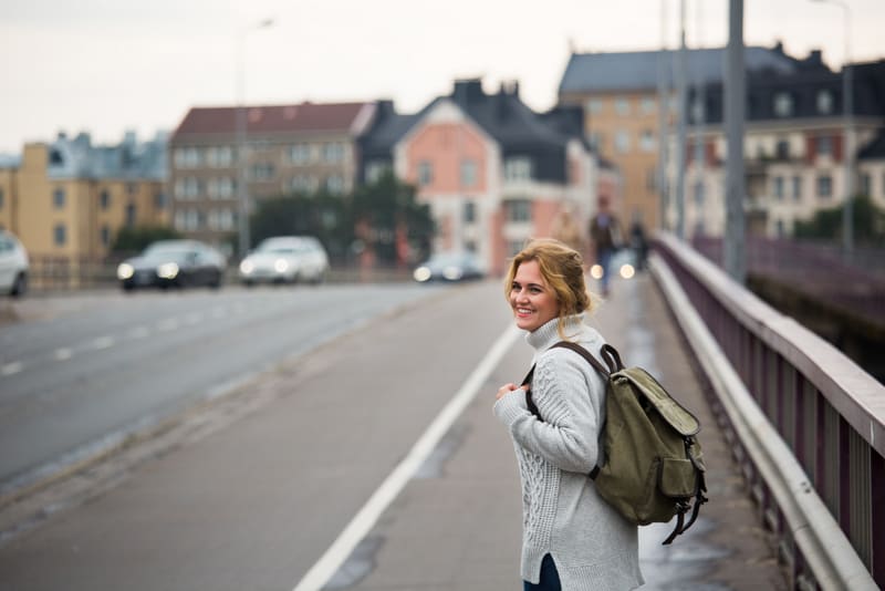 A woman traveler with backpack on a street