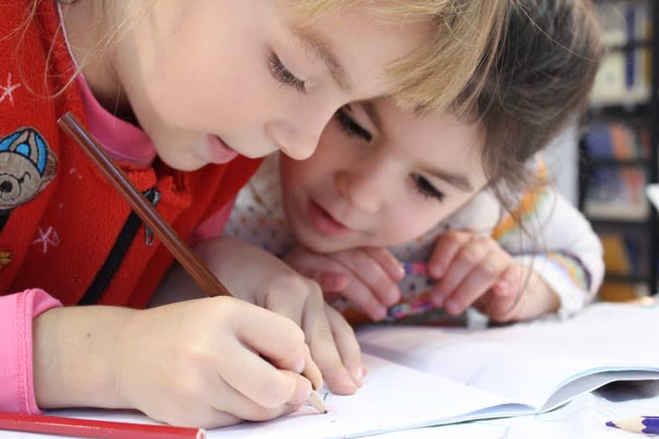128368_girls-on-desk-looking-at-notebook-159823.jpg
