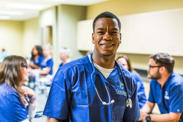 Graceland Nursing Student An African-American nursing student in a lab classroom setting.