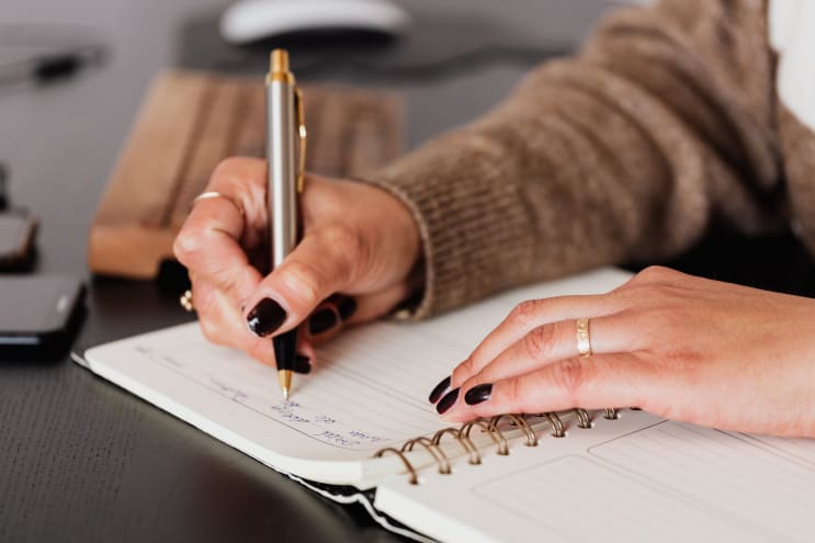 Woman writing notes on paper