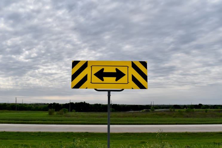 Yellow directional sign on a country highway